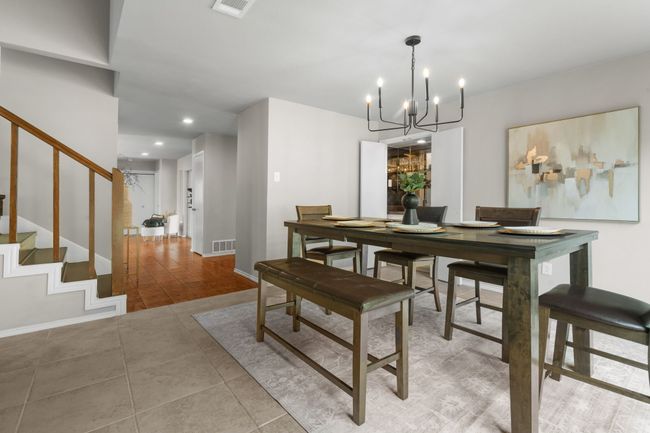 Dining room featuring a chandelier, stairs, light tile patterned flooring, recessed lighting, and baseboards | Image 26