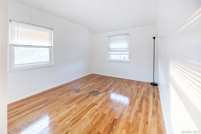 Spare room with light wood-type flooring and lofted ceiling | Image 20