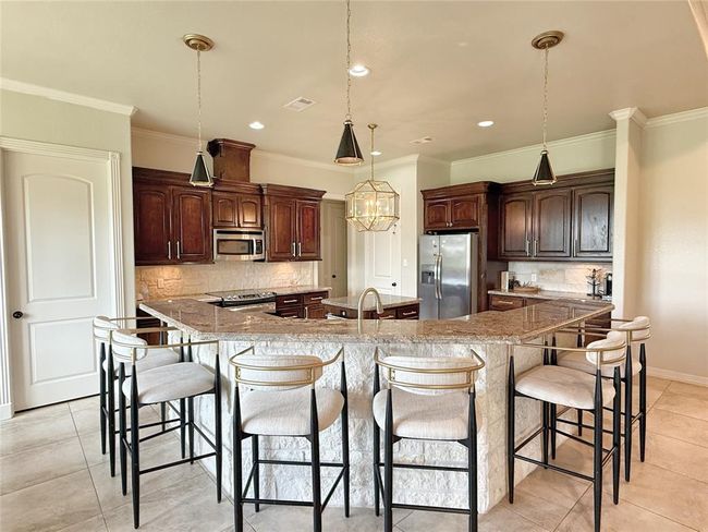 Spacious Breakfast Bar with granite countertops and stainless steel appliances | Image 5