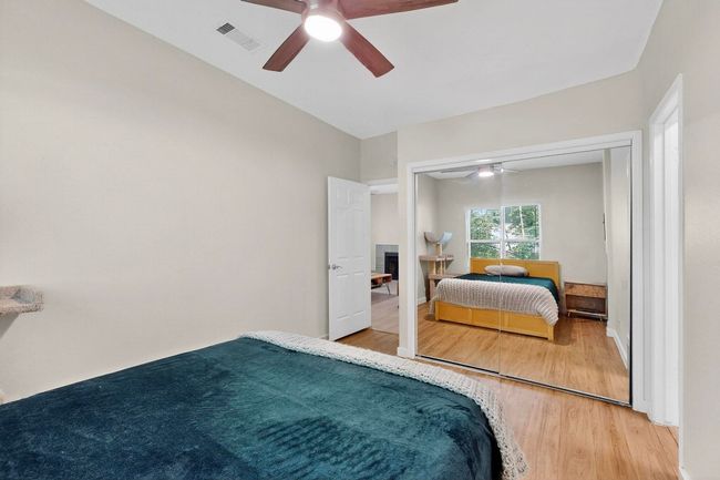 Bedroom featuring wood finished floors, ceiling fan, and a closet | Image 22