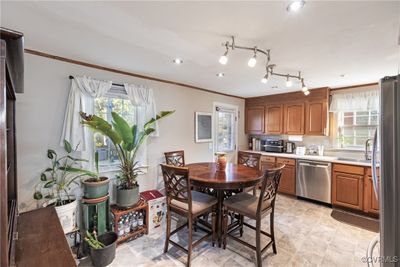 Kitchen featuring ornamental molding, sink, appliances with stainless steel finishes, and a healthy amount of sunlight | Image 2