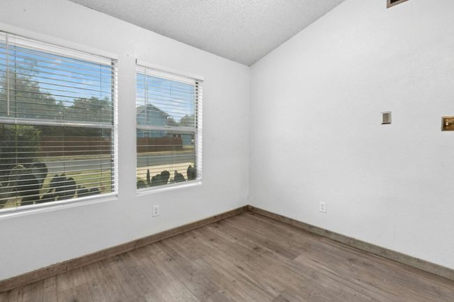 Spare room with lofted ceiling, a textured ceiling, and wood finished floors | Image 17