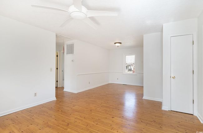 Empty room featuring ceiling fan and light wood-type flooring | Image 15