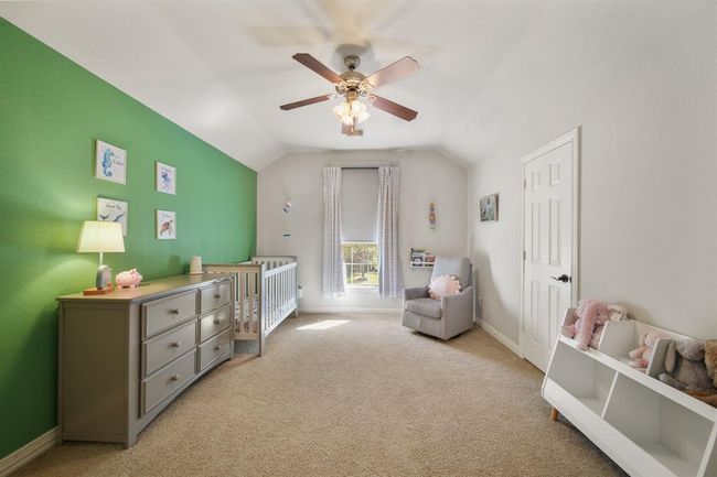The fourth bedroom has a high ceiling with ceiling fan & lighting, window with shade, a walk-in wardrobe closet & carpet. | Image 36