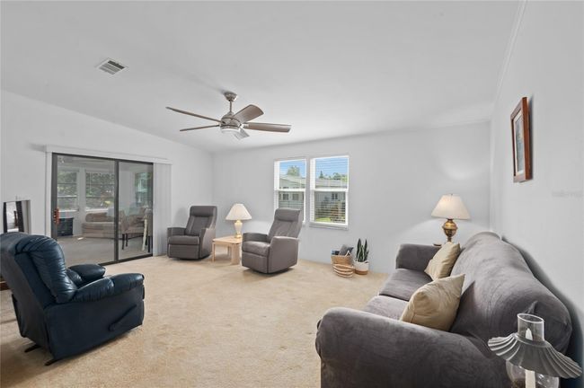 Living room with view leading out to the lanai | Image 12