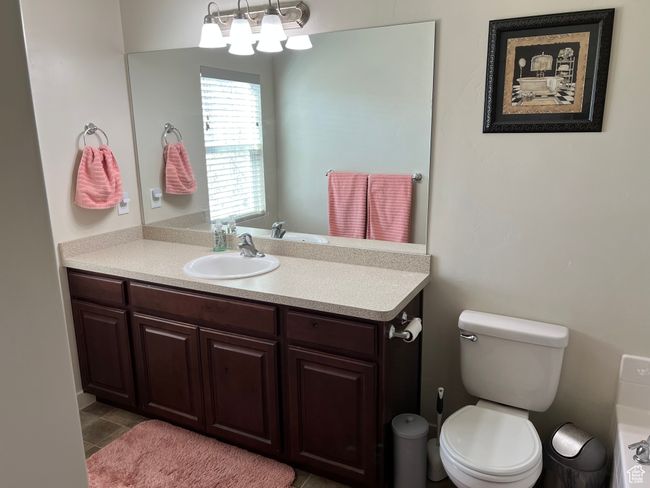 Bathroom with toilet, tile patterned floors, and vanity | Image 24