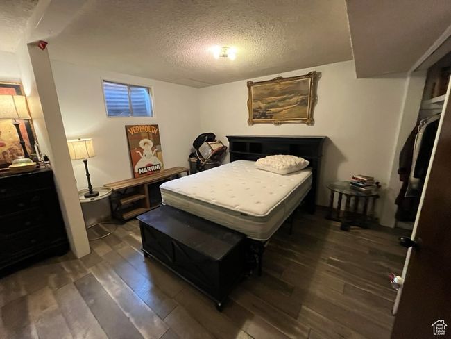 Bedroom with a textured ceiling and hardwood / wood-style flooring | Image 29