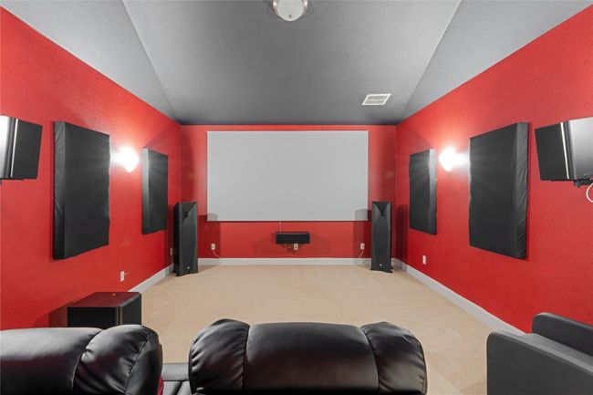 Home theater with vaulted ceiling and carpet floors | Image 34
