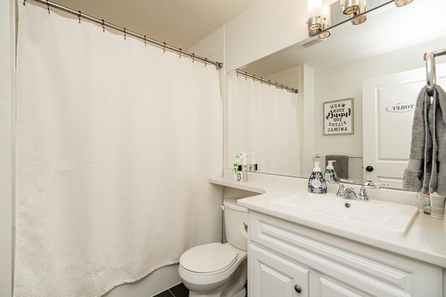 Bathroom with toilet, visible vents, and vanity | Image 17