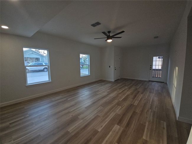 Unfurnished room with ceiling fan, visible vents, baseboards, and dark wood finished​​‌​​​​‌​​‌‌​‌‌​​​‌‌​​‌‌​‌​​​​​‌ floors | Image 6