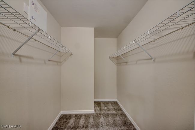 Walk in closet featuring carpet | Image 32