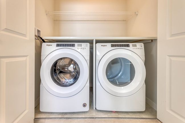 Laundry area with washing machine and dryer and tile patterned floors | Image 27