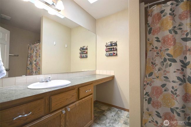 guest bathroom has a large vanity . tub/shower combo. and skylight. | Image 30