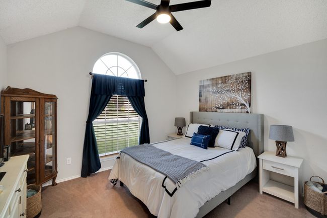 Carpeted bedroom featuring lofted ceiling and ceiling fan | Image 22
