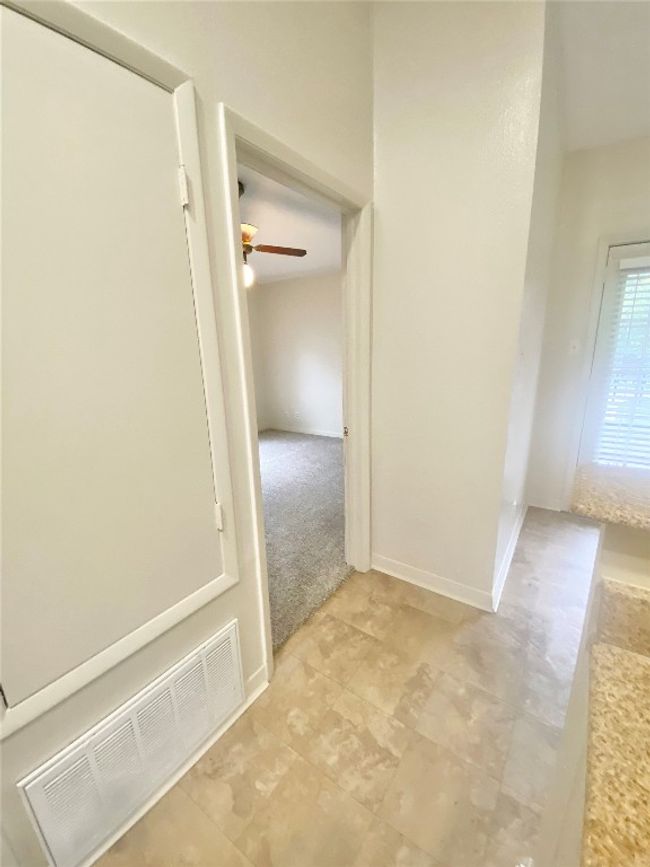 Corridor with light tile patterned floors and visible vents | Image 18