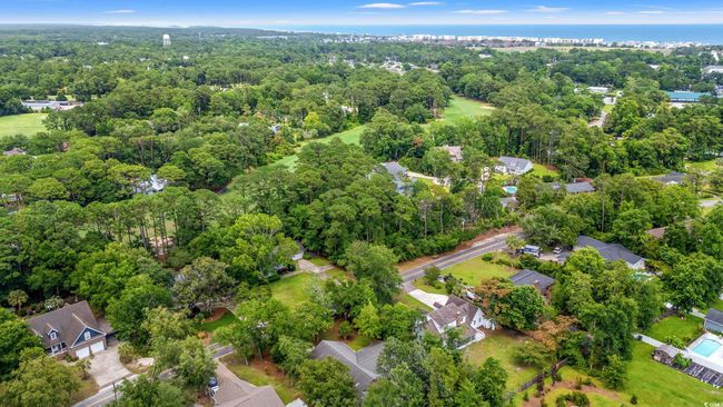 Aerial view of property and surrounding area featuring a heavily wooded area | Image 34