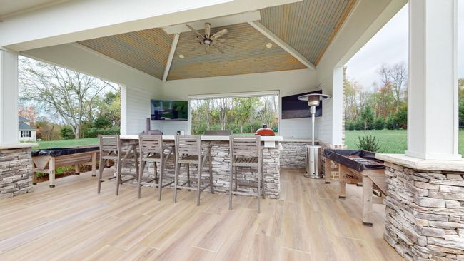 This one-of-a-kind outdoor oasis features a stunning stone pavilion, perfect for dining under the stars and equipped with everything you need for the ultimate grilling experience | Image 57