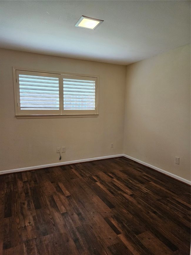 Empty room featuring dark wood-style flooring and baseboards | Image 14