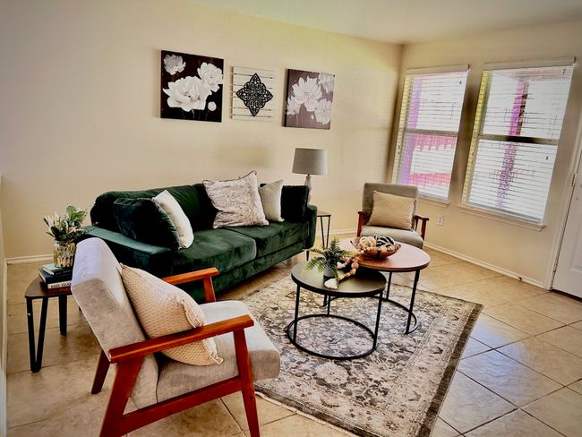 Living room featuring plenty of natural light and light tile patterned flooring | Image 9