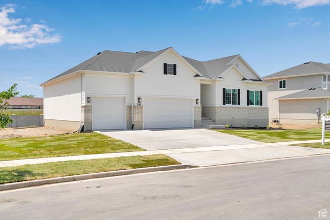 Traditional-style house with driveway, an attached garage, and brick siding | Image 29