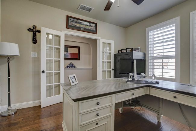 Office space with dark wood-type flooring, ceiling fan, and french doors | Image 4