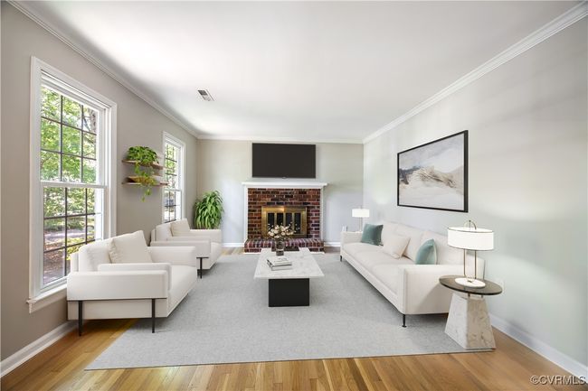 Living room with ornamental molding, light wood finished floors, and a brick fireplace | Image 4