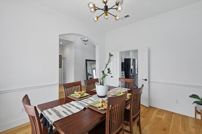Clean, bright white colors with warm sold wood floors. Note pass-through to kitchen. | Image 9