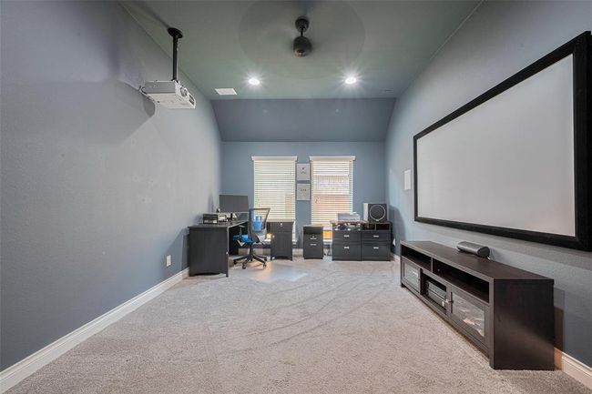 This versatile space with double glass doors is currently used as a home office but could easily serve as a child's playroom or media room. The Epson projector and screen convey with the property, (plus it has built in speakers) making it ready for movie nights or presentations. | Image 9