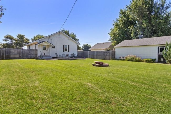 View of yard featuring a fire pit and a fenced backyard | Image 6