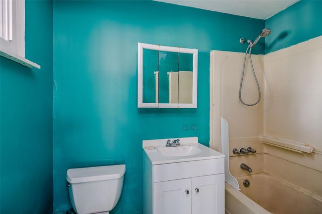 Full bath featuring toilet, vanity, and washtub / shower combination | Image 25