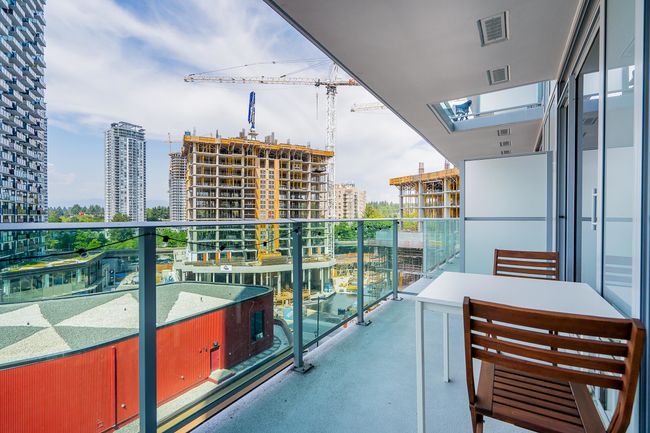 Balcony with a view of city and visible vents | Image 17
