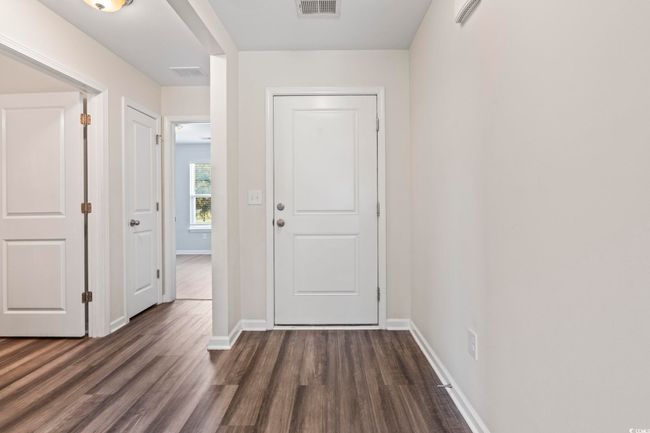 Foyer with dark wood finished floors and baseboards | Image 7