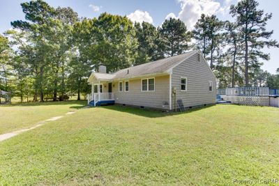 View of front facade featuring a front yard and a deck | Image 1