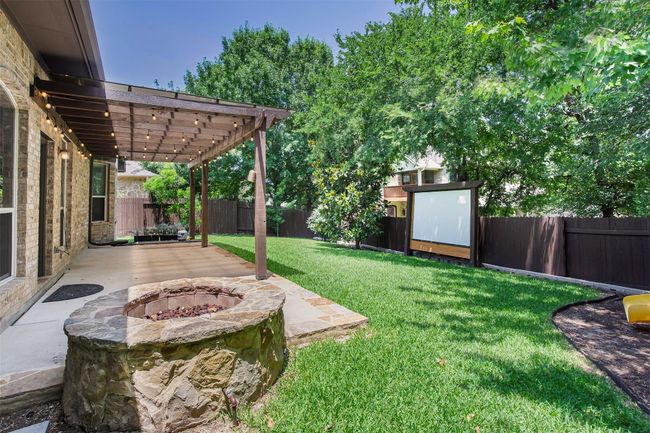 View of yard featuring a patio area, an outdoor fire pit, and a pergola | Image 37