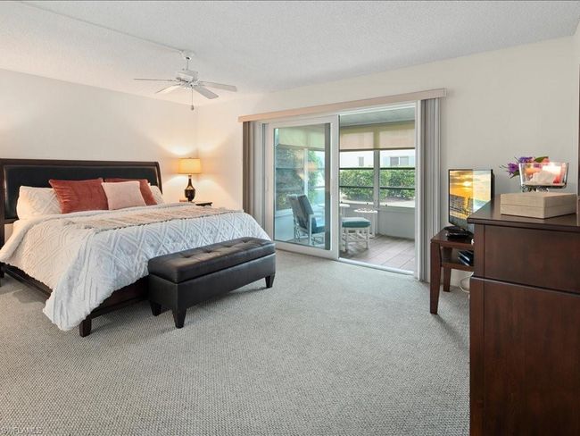 Very spacious bedroom featuring access to exterior and a ceiling fan | Image 4