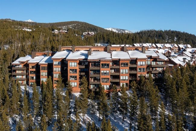 Snow covered property with a mountain view | Image 29