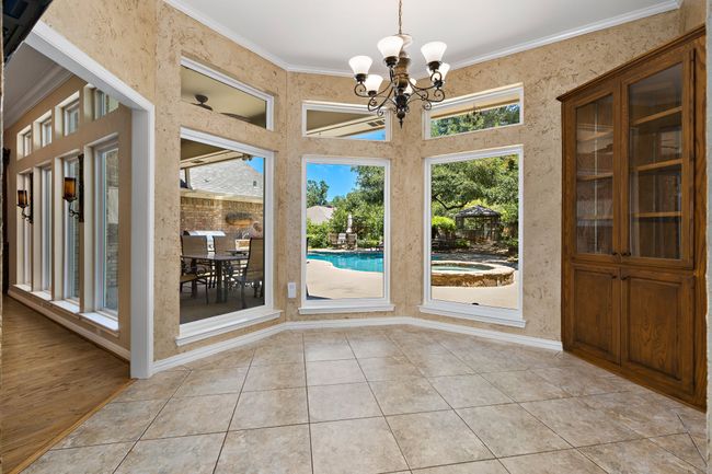 Sunny breakfast room overlooking pool with built-in hutch | Image 10