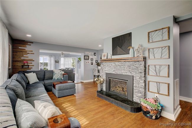 Living room with ceiling fan, a fireplace, and wood-type flooring | Image 27