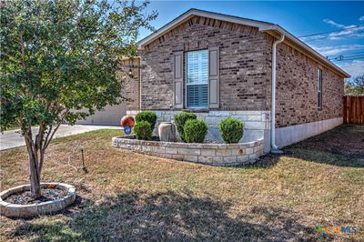 Pretty curb appeal with rock landscaped rock garden & tree. | Image 3