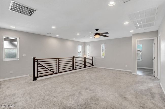 Carpeted empty room featuring recessed lighting, baseboards, a ceiling fan, and attic access | Image 28