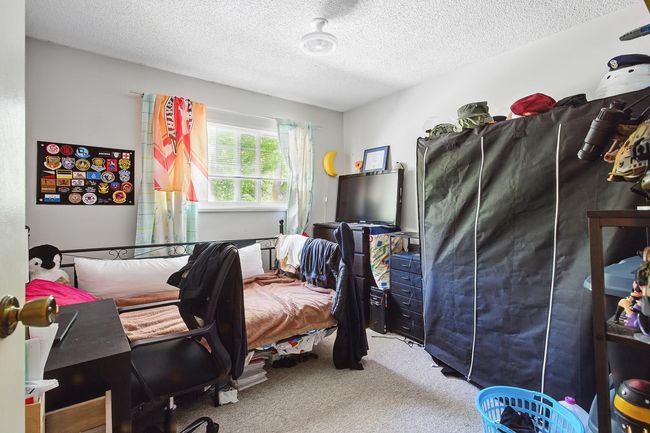 Bedroom featuring carpet flooring and a textured ceiling | Image 19