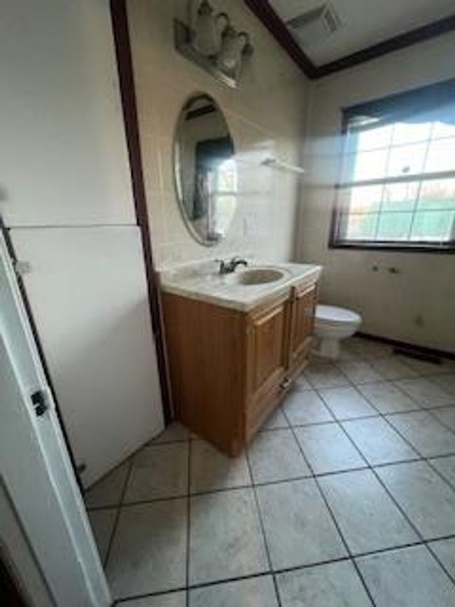 Bathroom with vanity, toilet, and tile patterned floors | Image 7