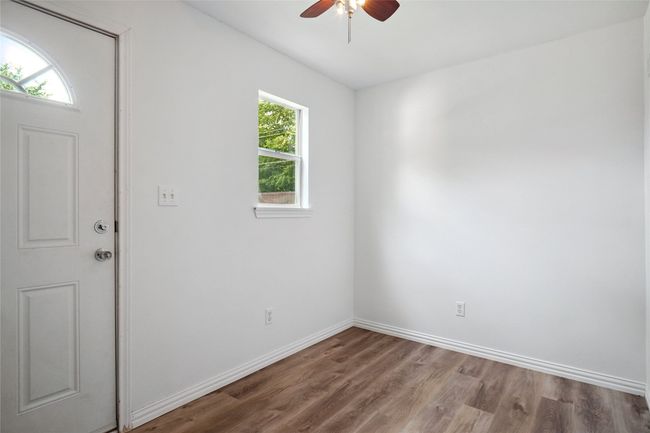 Building #1 with plenty of natural light, ceiling fan, and wood finished floors | Image 21
