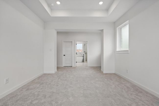 Spare room with a raised ceiling, light carpet, baseboards, recessed lighting, and a smoke detector | Image 23