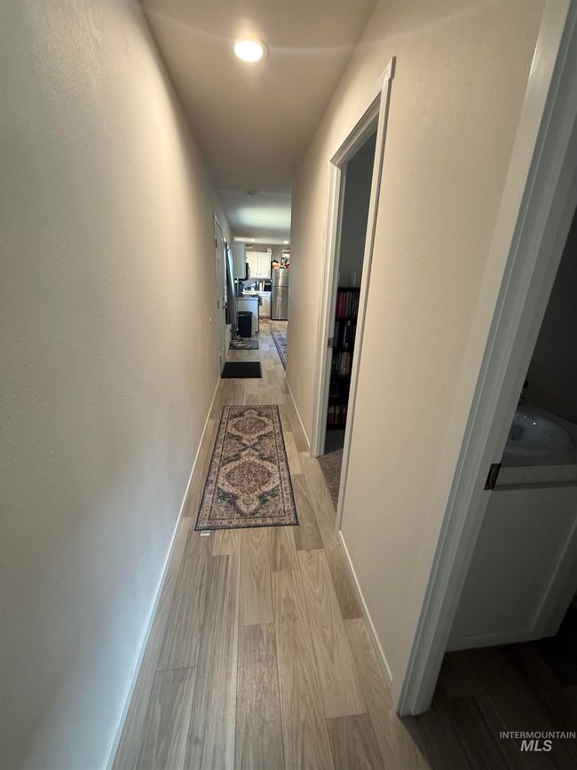 Corridor featuring light wood-style floors and baseboards | Image 13
