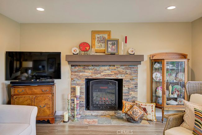 Fireplace is the centerpiece of the living room. | Image 9