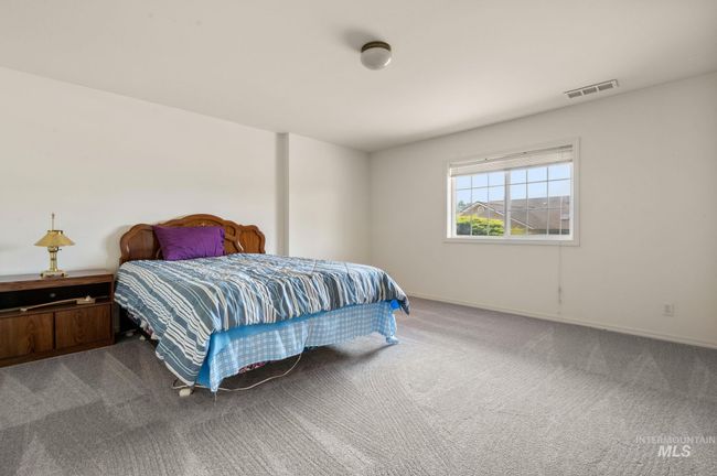 Carpeted bedroom featuring baseboards | Image 28