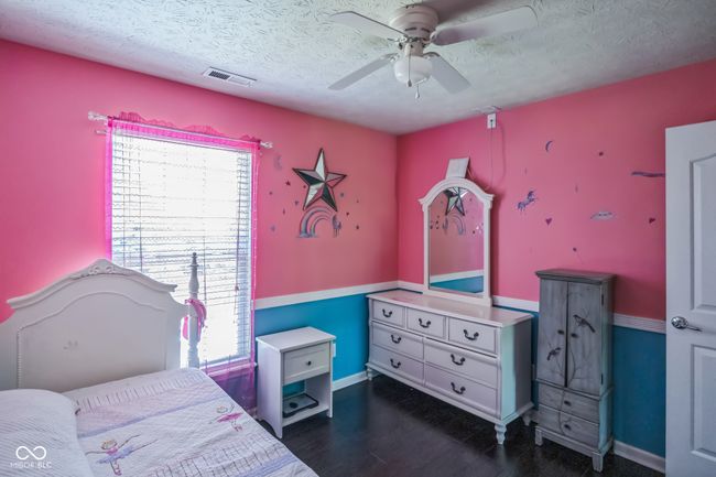 bedroom featuring a textured ceiling, dark wood-style flooring, and ceiling fan | Image 27