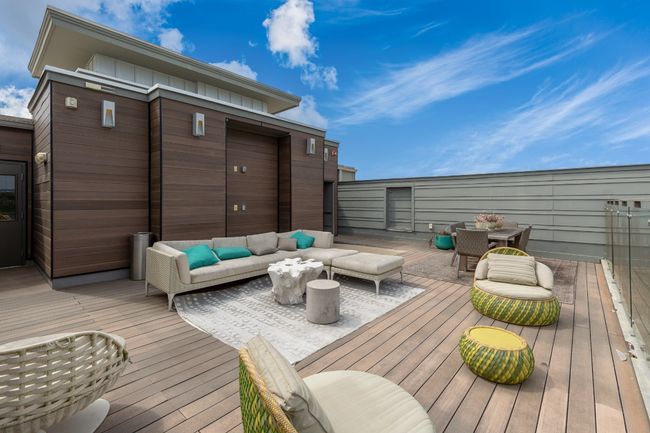 Wooden terrace with an outdoor hangout area and outdoor dining space | Image 11