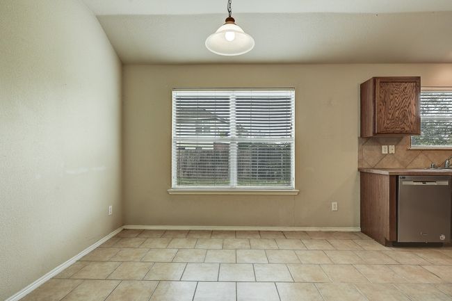 Unfurnished dining area featuring baseboards and light tile patterned flooring | Image 16